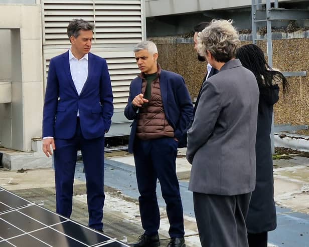 Ed Miliband and Sadiq Khan examine solar panels on a roof of a school in Stoke Newington