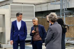 Ed Miliband and Sadiq Khan examine solar panels on a roof of a school in Stoke Newington