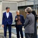 Ed Miliband and Sadiq Khan examine solar panels on a roof of a school in Stoke Newington