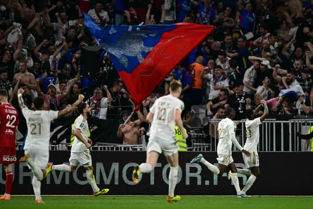 Maitland-Niles celebrates with Lyon teammates.