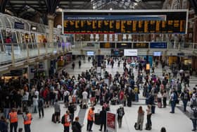 People wait for a train at Liverpool Street station.