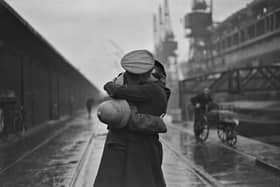 December 4 1934:  A soldier kissing his wife at King George V's dock, London, after returning from being stationed in India.  (Photo by Douglas Miller/Topical Press Agency/Hulton Archive/Getty Images)
