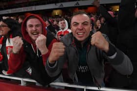 Arsenal fans celebrate the third Arsenal goal.