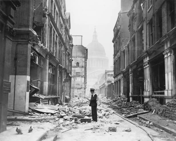 A postman tries to deliver letters to premises in Watling Street in the City of London, after a night time German air raid, London, May 1941. The dome of St Paul's Cathedral is in the background. (Photo by Central Press/Hulton Archive/Getty Images)