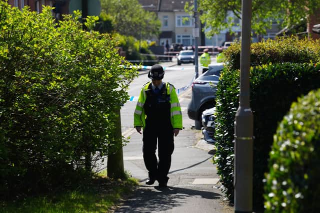 A police officer secures the scene after a sword attack in Hainault.
