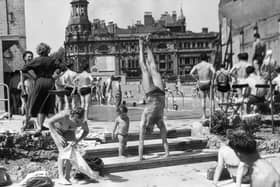 circa 1950:  A man performs a handstand amid swimmers and sunbathers at the Oasis baths in Endell Street, Holborn.  (Photo by Hulton Archive/Getty Images)
