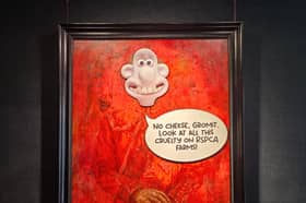 Animal rights activists have targeted King Charles’ first official portrait by pasting the animated character Wallace over his face.
