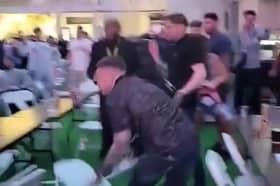 Men can be seen throwing chairs across the room at the Winter Gardens first Euros Fanzone match. 