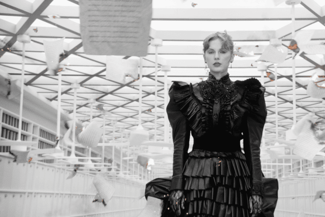 Swift's black ruffled dress, as seen in the music video Fortnight, is one of a number of objects on loan from Swift's personal archive