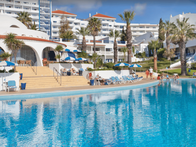 Lounge by the pool at the Grand Muthu Oura View Beach Club