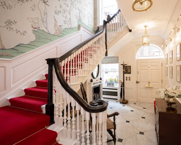 A stunning entrance with handpainted silk wallpaper and amazing stairwell.