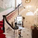 A stunning entrance with handpainted silk wallpaper and amazing stairwell.