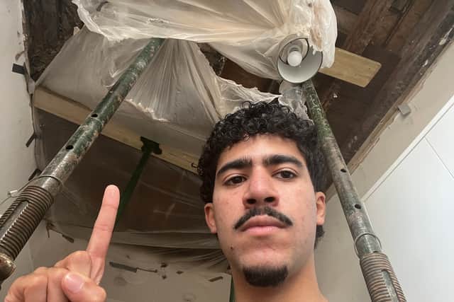 Cesar Medina and the hole in the kitchen ceiling of his family's flat in Hammersmith