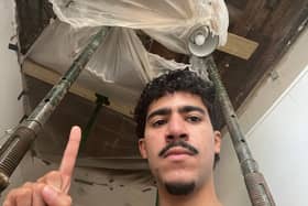 Cesar Medina and the hole in the kitchen ceiling of his family's flat in Hammersmith