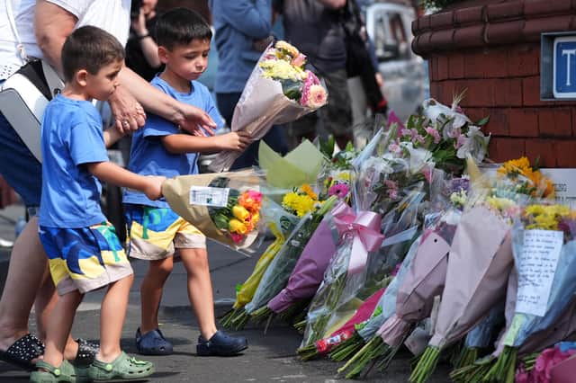 Tributes to the victims of the mass stabbing in Southport are left by wellwishers.
