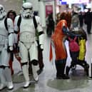 Cosplayers attend the MCM Comic Con at ExCeL exhibition centre in London on October 27, 2023. (Photo by HENRY NICHOLLS / AFP) 