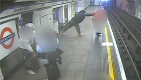 Man shoves stranger onto tracks as train arrives at platform.