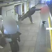 Man shoves stranger onto tracks as train arrives at platform.