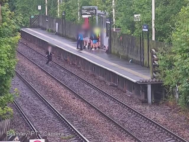A child jumping onto the tracks in front of a train. 