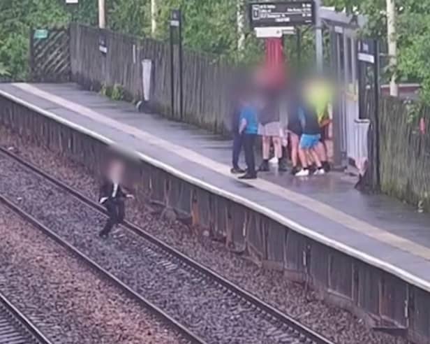 A child jumping onto the tracks in front of a train. 