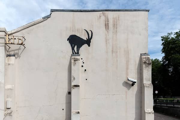 The new artwork features a goat silhouette with rocks falling down below it