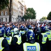 Police officers kettle protestors during the 'Enough is Enough' demonstration on Whitehall, on July 31