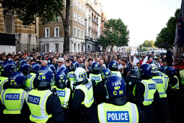 Police officers kettle protestors during the 'Enough is Enough' demonstration on Whitehall, on July 31