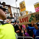 Residents hold placards during a counter demonstration against an anti-immigration protest called by far-right activists in the Walthamstow