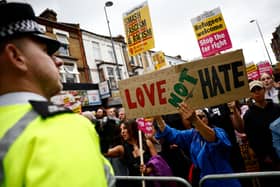 Residents hold placards during a counter demonstration against an anti-immigration protest called by far-right activists in the Walthamstow