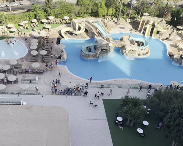 Tourists race to get sunbeds after queuing for pool to open.