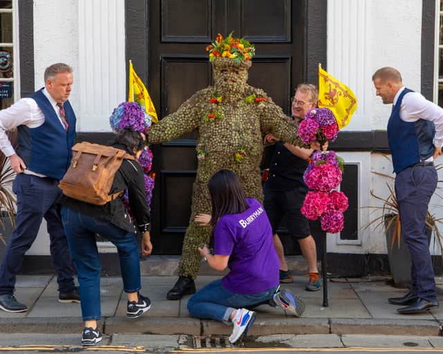 The Burryman covered head to toe in over 13,000 sticky plant heads walks the boundary of South Queensferry to ward off evil spirits as part of a 900-year-old traditional historic parade.