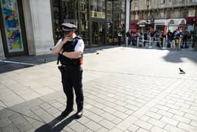 A police officer stands near a cordoned area following a double stabbing at Leicester Square 