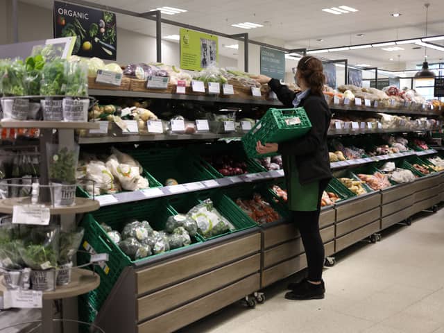 An employee stacks shelves at a Waitrose supermarket in London (Photo: HOLLIE ADAMS/AFP via Getty Images)