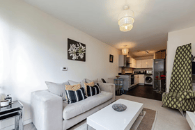 This one-bedroom apartment features an open-plan reception room with a Juliette balcony and a modern kitchen