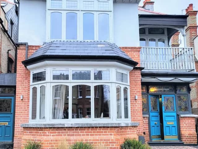Bright blue doors and a stunning balcony are all idyllic features of this Compton Road house for sale. 