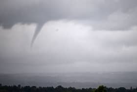 A funnel cloud is seen north of the racecourse on Qipco British Champions Day at Ascot Racecourse, west of London on October 21, 2023. 