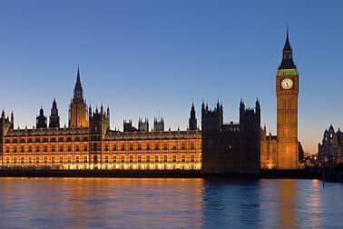 The Palace of Westminster at night as seen from the opposite side of the River Thames.