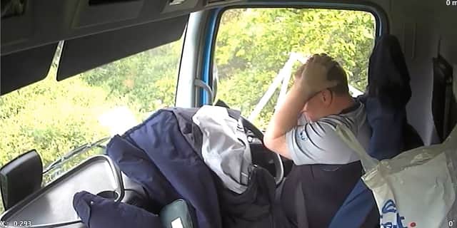 Lorry driver crashed into car after looking at phone.