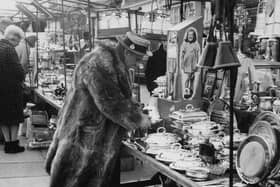 A character browsing the stalls at Portobello Road market, London in 1966