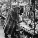 A character browsing the stalls at Portobello Road market, London in 1966