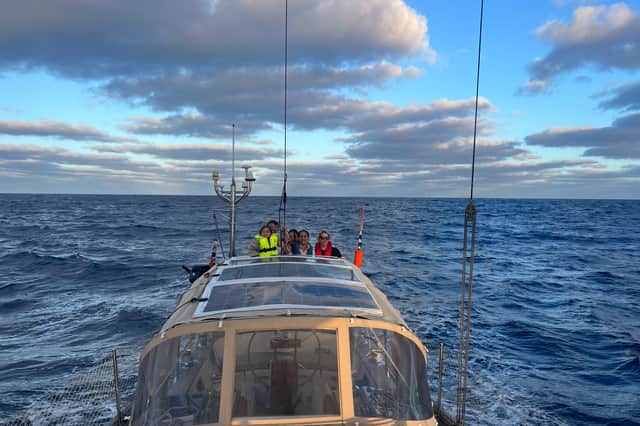 Dan Monk, his wife Bow, and their children Amelia and Olivia sailing on their yacht, Pancakes.