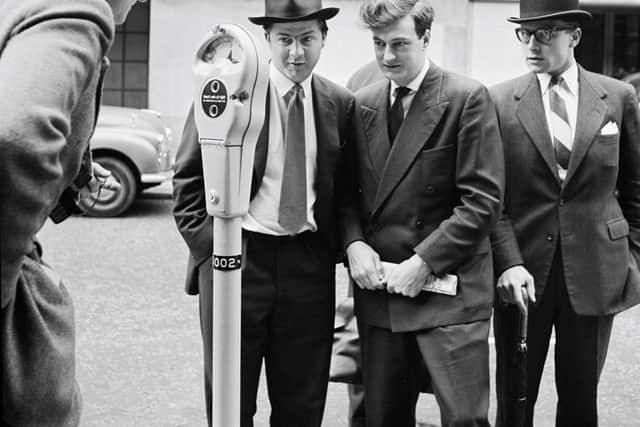 A group of men looking at one of the first parking meters installed in the UK at Mayfair, London, July 9th 1958.