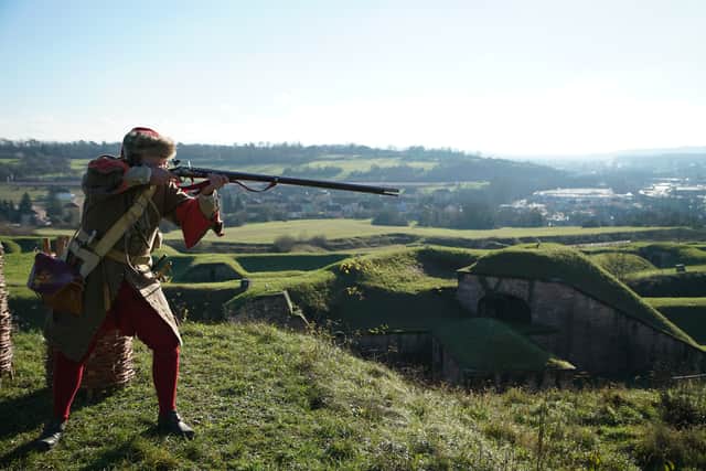 A reenactor firing a musket at Belfort Citadel, France. The iconic site played a vital role in the Franco-Prussian war