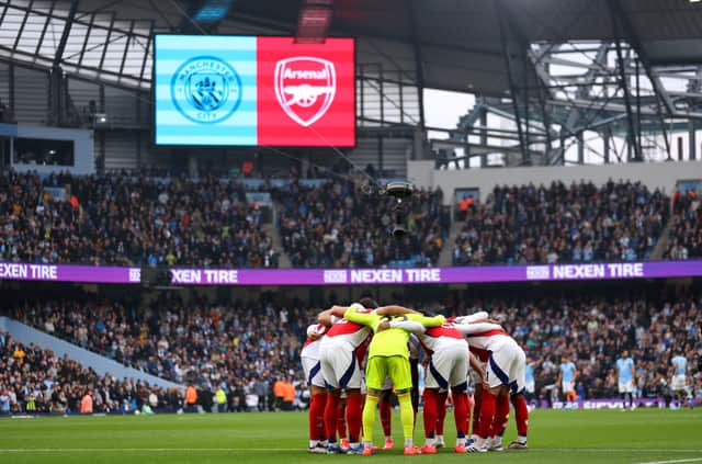 Arsenal players huddle prior to facing Manchester City.