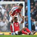 Jurrien Timber is helped to his feet during Manchester City vs Arsenal clash by William Saliba