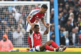 Jurrien Timber is helped to his feet during Manchester City vs Arsenal clash by William Saliba