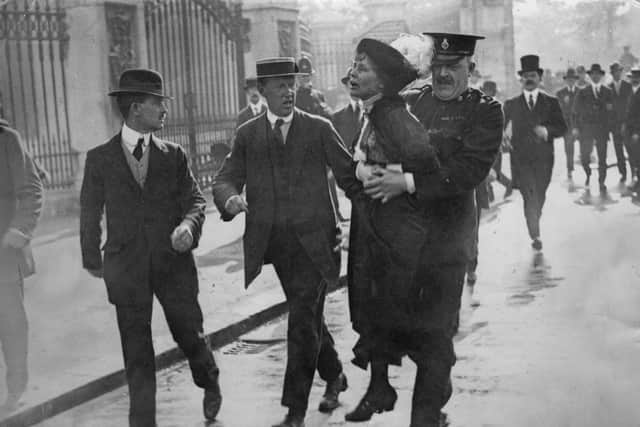 Outside Buckingham Palace, English suffragette Emmeline Pankhurst (1858 - 1928), is arrested and carried away by Superintendent Rolfe