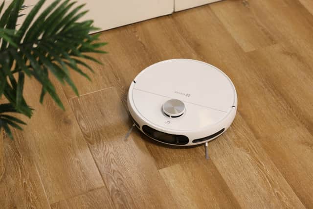 The robot is a traditional round shape, with dual spinning brushes that help it clean out corners and edges