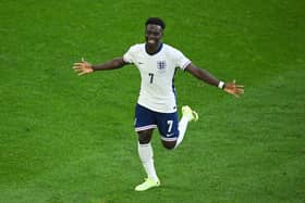 Bukayo Saka celebrates scoring for England.