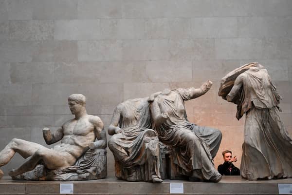 Visitors view the Parthenon Marbles, also known as the Elgin Marbles, at the British Museum in London